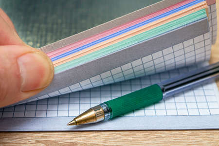 a person opens a notebook for writing in which there is a fountain pen. High quality photoの写真素材