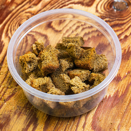 crispy rye crackers in a plastic cup on a wooden table top view. High quality photoの写真素材