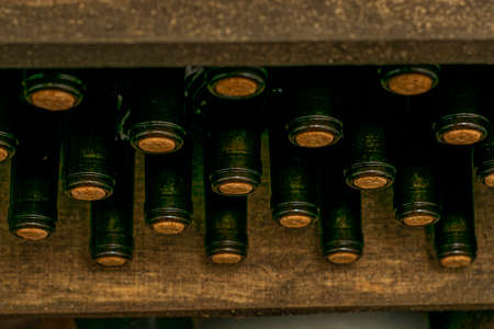 bottles of dry red wine stacked on a shelf in the wine cellar. High quality photoの写真素材