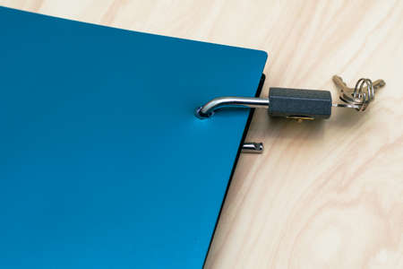 the concept of information protection is an open lock with keys hanging on the notebook for notesの写真素材