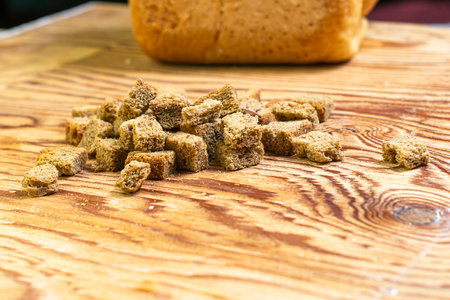 rye crackers on a wooden table in the background in a blur a loaf of bread. High quality photoの写真素材