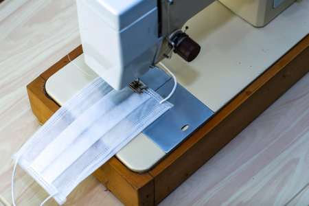 the sewing machine sews protective medical mask. High quality photoの写真素材