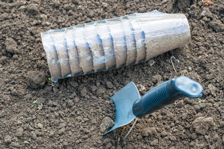 peat pots for seedlings and a garden shovel on the dug up ground concept gardening farming spring....
