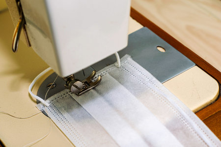 the sewing machine sews protective medical mask. High quality photo