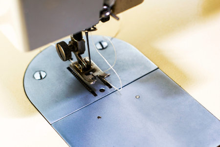 sewing machine close up needle shuttle and thread. High quality photo