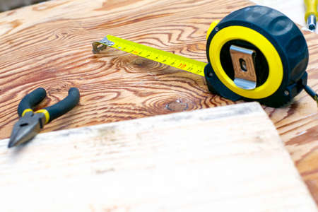 measuring tape measure board and pliers on the workbench. High quality photoの写真素材