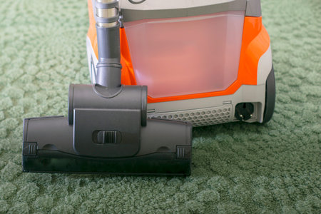 washing vacuum cleaner on the background of a green carpet. High quality photoの写真素材