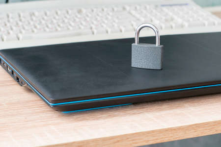 closed iron padlock on the laptop concept information protection. High quality photoの写真素材