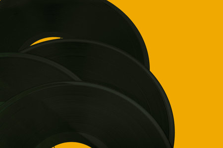 old vinyl records on a yellow background close-up. High quality photoの写真素材