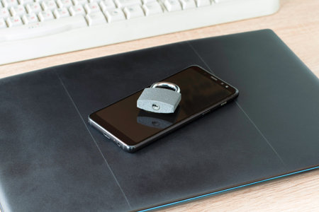 iron padlock on smartphone and laptop concept information protection internet censorship. High quality photoの写真素材