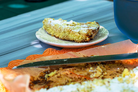 shortbread pie knife and mug of tea on the garden table on a sunny day. High quality photo