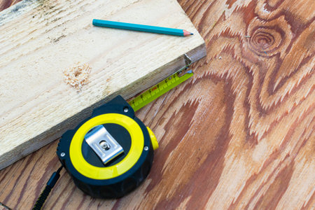 measuring tape pencil and fosca on the workbench concept craft construction. High quality photo