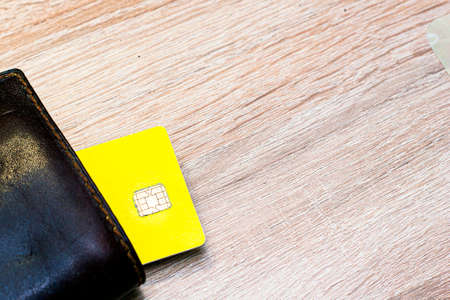 a credit card sticks out of a wallet lying on the copyscape table. High quality photoの写真素材
