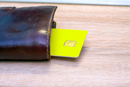 a credit card sticks out of a wallet lying on the copyscape table