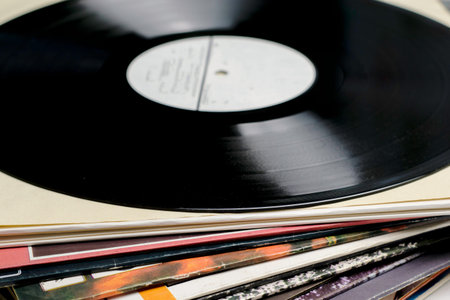 a stack of old vinyl records close up one of the records is taken out of the envelope. High quality...