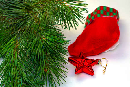 christmas card pine branches christmas decorations and santa claus stocking on a white background. High quality photoの写真素材