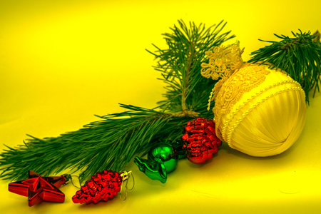 pine branch with christmas decorations copyspace yellow tinted. High quality photoの写真素材