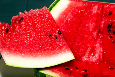 red ripe juicy watermelon with a cut off segment close-up background. High quality photo