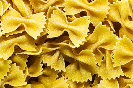 raw italian pasta farfalle close-up for background background. High quality photoの写真素材