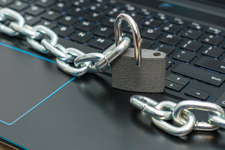 an iron chain, an open padlock on a computer keyboard the concept of data protection censorship on the Internet. High quality photoの写真素材