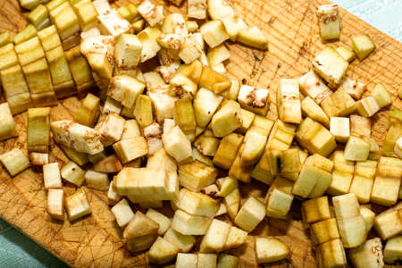 diced eggplant on a wooden cutting board close-up. High quality photoの写真素材