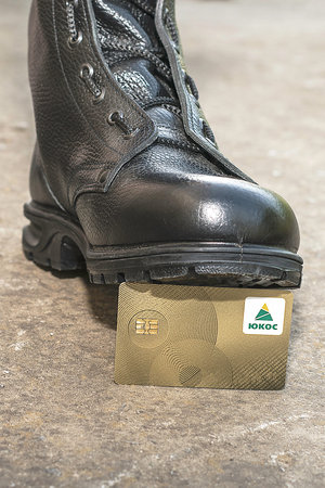 07.29.2021 Divnoye Stavropol Territory Russia an army boot tramples on the golden refueling card of...