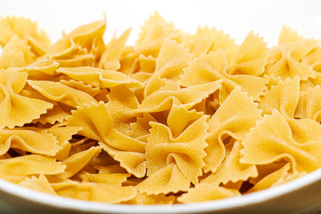 raw italian pasta farfalle close-up in a white plate. High quality photo