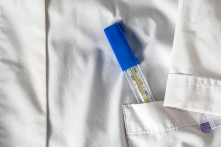 medical thermometer in the side pocket of a white medical coat. High quality photoの写真素材