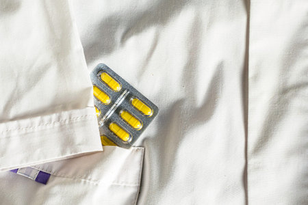 a blister with pills in the side pocket of a white medical coat. High quality photo