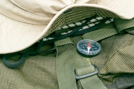 on the tourist backpack there is a hat and a compass the concept of tourism travel. High quality...