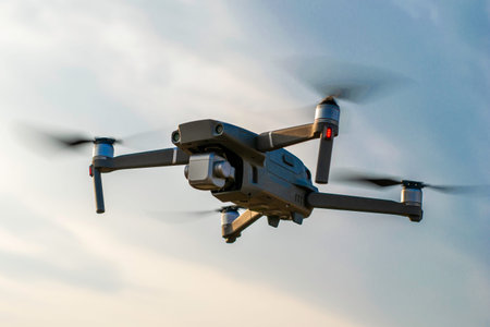 a quadrocopter drone flies against the background of the sky with clouds. High quality photo