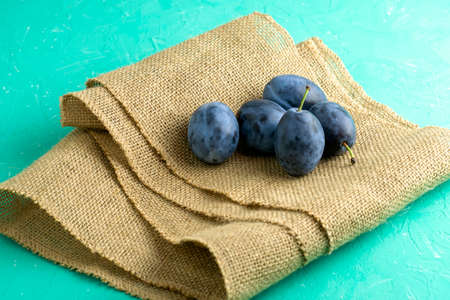 freshly picked ripe plums on a piece of burlap. High quality photoの写真素材