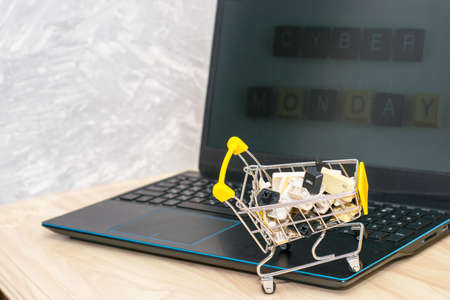 laptop and shopping cart with computer keyboard buttons concept cyber monday online trading. High quality photoの写真素材