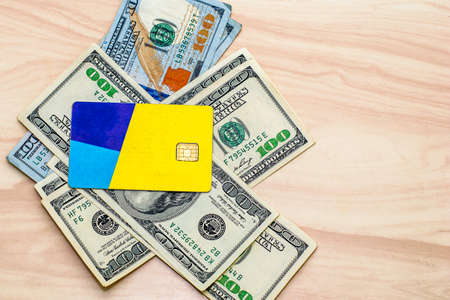 the credit card on the hundred-dollar bills lying on the table. High quality photoの写真素材