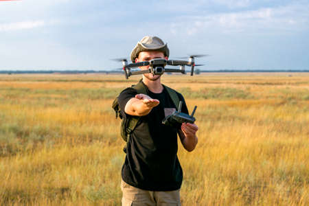 a tourist guy launches a quadcopter with his hand in front of him. High quality photoの写真素材