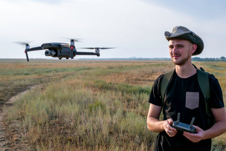 a videographer launches a quadrocopter against a blue sky. High quality photoの写真素材