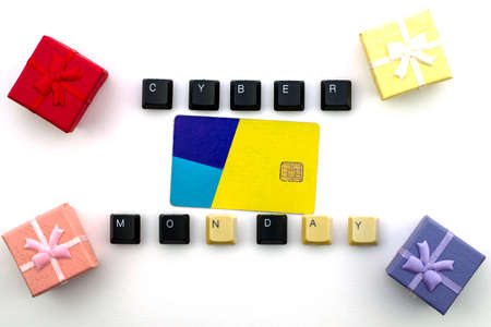 The phrase cyber Monday is laid out from the keys of a computer keyboard, in the middle are a credit card and gift boxes on a white background. High quality photoの写真素材