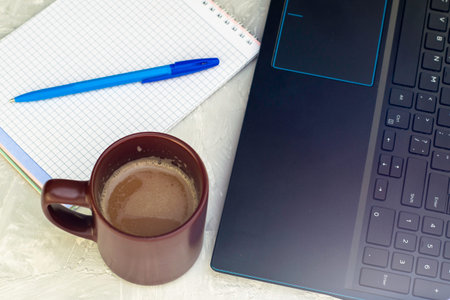 coffee mug laptop and notebook with a fountain pen on the table