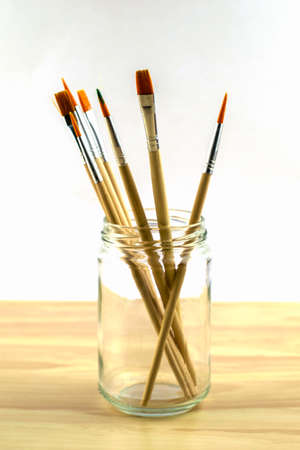 brushes for drawing of various diameters in a glass jar on a white background. High quality photoの写真素材