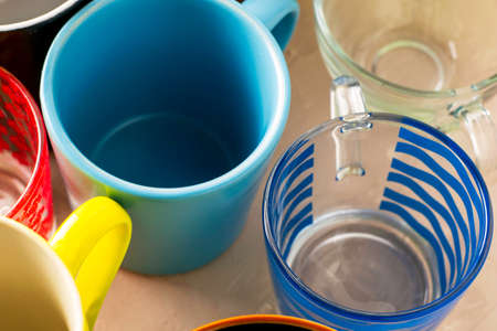 empty mugs of different shapes and sizes on the table. High quality photoの写真素材