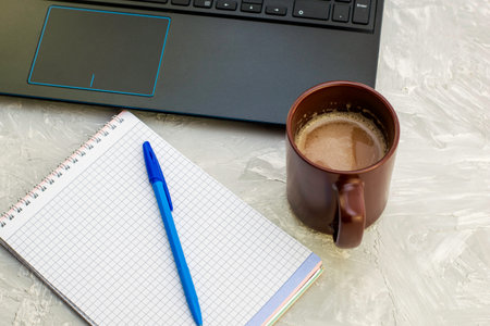 coffee mug laptop and notebook with a fountain pen on the table. High quality photo