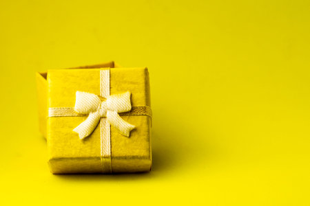 yellow gift box with an open lid on a yellow background with copyspace. High quality photoの写真素材