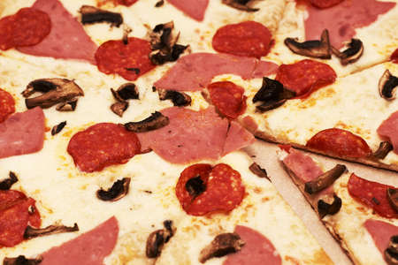 pepperoni pizza with ham and mushrooms close-up. High quality photoの写真素材