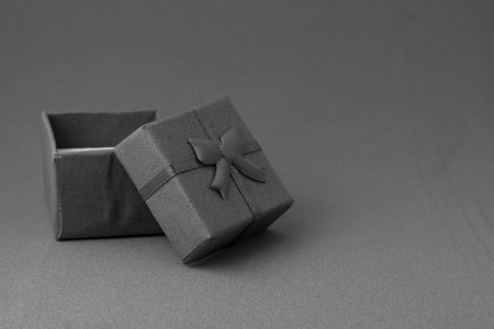 gray gift box with open lid on gray background with copyspace. high quality photoの写真素材