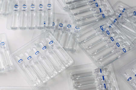 plastic transparent containers with glass ampoules on a white background. High quality photoの写真素材