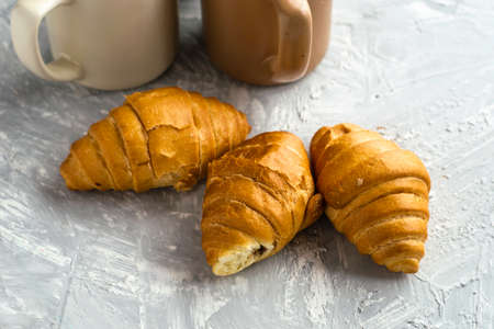coffee mugs and croissants on the table. high quality photoの写真素材