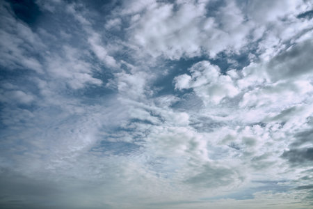 blue cloudy sky on a sunny day background screensaver backdrop. high quality photo