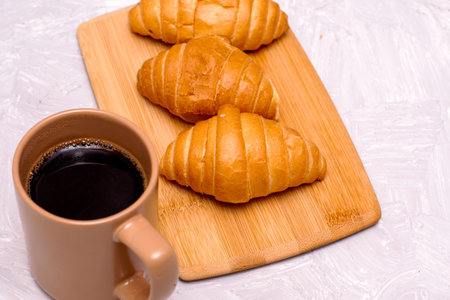 mug of coffee and croissants on the table. high quality photo