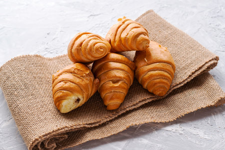 fresh croissants with chocolate filling on burlap. high quality photo