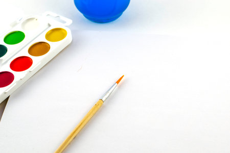 watercolor paints brush jar with water and sketchbook on a white background. high quality photoの写真素材